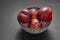 Nice Bowl with black and white color full of ripe red nectarines ready to eat