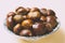 A nice bowl of chestnuts on beige background