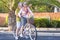 Nice caucasian senior adult couple have fun going and moving on a vintage bike together. woman carry a man on an old bicylcle in