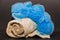 Nice closeup view of beige towel and blue fluffy sponge isolated on dark