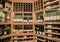 nice closeup view of various wine on wooden shelf`s inside cozy wine store