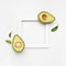 Nice composition of avocado on white background with a frame for text