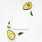 Nice composition of avocado on white background with a frame for text