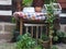 Nice corner in a medieval garden with wooden table and colorful tablecloth and green plants