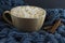 Nice Cup of coffee with marshmallow. Blue knitted background
