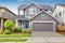 Nice curb appeal of two level house, mocha exterior paint and concrete driveway