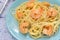 A nice delicious dinner. Spaghetti with shrimps on blue plates.