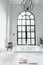 Nice design jacuzzi bathtub with high transparant window in natural light setting scene / cozy interior concept / wellness