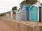 a nice even row of beach huts with fence in front down in dovercourt harwich