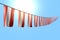 nice feast flag 3d illustration - many Austria flags or banners hangs diagonal on rope on blue sky background with selective