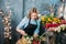 Nice female with rose on hair working with flowers