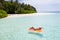 Nice fit slim thin attractive girl freelance living on island floating lying on rubber mattress ocean water enjoy joy