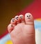 Nice foot of a baby with many faces painted