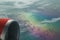 Nice fragment of a view from on aircraft climbing above rainbow beautiful color clouds that bring attention