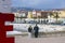 Nice, France, March 2019. Panorama. Azure sea, waves, English promenade and people resting. Young couple: a man and a woman look