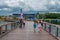 Nice girl raising her arms while walking with her family at Seaworld .