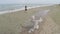 Nice girl running along the beach, athlete training on seashore, aerial shot