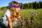 Nice girl among wildflowers and butterflies