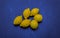 Nice gorgeous view of appetizing yellow organic fresh lemons on dark cold blue
