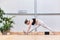 nice Hispanic woman pose performing yoga stretches and warm-ups in a gym