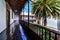 Nice interior patio with palm trees and corridor around the patio in sunny day and blue sky, Europe