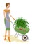 A nice lady in work clothes. The girl is carrying a garden wheelbarrow with flowerpots with a yucca plant. A woman works as a