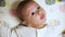 A nice little caucasian newborn baby is funny smiling, Portrait of a playful and energetic child close-up