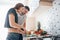 Nice looking interior. Young couple in the modern kitchen at home at their weekend time in the morning