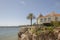 Nice low house on a cliff at the edge of the sea near a recreational pier on the coast of Estoril