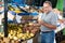 Nice man is choosing potato in the store