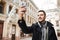 Nice man taking selfie while walking around beautiful city.