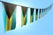 nice many Bahamas flags or banners hanging diagonal on string on blue sky background with bokeh - any feast flag 3d illustration