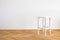 nice modern simplistic white chair on a wooden floor in front of white background