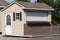 a nice new gray storage shed roof door window