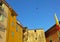 Nice old house, colorful houses, roofs, paragliding in the blue sky. Cote d`Azur, French Riviera, Provence, France