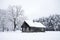 Nice old village house in the middle of beautiful winter with lots of white snow and trees.