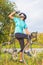 Nice Portrait of young female cyclist athlete having a water break.