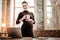 Nice pregnant businesswoman holding a cup with tea