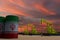 Nice pumpjack oil extraction and cloudy sky in sunset with the IRAN flag on oil barrels 3D rendering