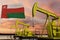 Nice pumpjack oil extraction and cloudy sky in sunset with the Oman flag