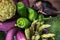 Nice raw vegetable still life of thin purple eggplants, green paprika peppers, plumps, artichoke, brocoli and asparagus. Fresh foo