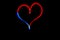 Nice red and blue heart drawn with a lamp during a lightpainting session at night.