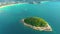 Nice rocks forested island, aerial panorama of Ko Pu against mountainous Phuket landscape on background. Deep tropical jungle