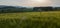 Nice rural czech landscape with wheat field, hill and trees at sunset