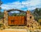 Nice rural door with a crossbar trunk and the mountains in the background