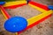 A nice sandbox playground filled . Surrounded by green grass,