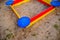 A nice sandbox playground filled . Surrounded by green grass,