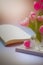 Nice slightly blurred background. The magazine is on the table, a vase of fresh flowers in soft pastel colors. Created with