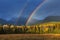 Nice summer rainbow over the mountains. Amazing rainy and cloudy day. Canadian Rocky Mountains, Canada.