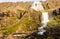 Nice summer view of Dynjandifoss Dynjandi Waterfall, jewels of the Westfjords, Iceland. The biggest waterfall in Westfjords